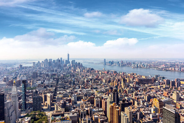 Cityscape of Manhattan under blue sky with clouds, New York City, USA