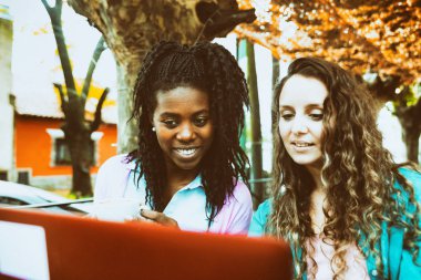 Two friends drink a cup of coffee and control social networks fr