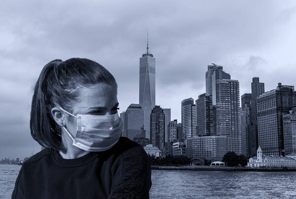 Young girl near Manhattan, NY, wears mask against Covid-19.