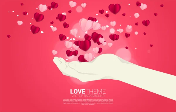 Arte de papel de coração voando do conceito de fundo da mão. Dia dos namorados e banner tema do amor e cartaz —  Vetores de Stock