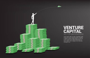 silhouette of businessman throw out money banknote origami paper airplane from money stack. Business Concept of start business and entrepreneur clipart