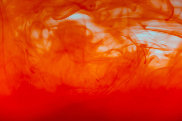 Close up red color ink Fluid liquid and smoke Abstract  background. Color drop flowing in water.