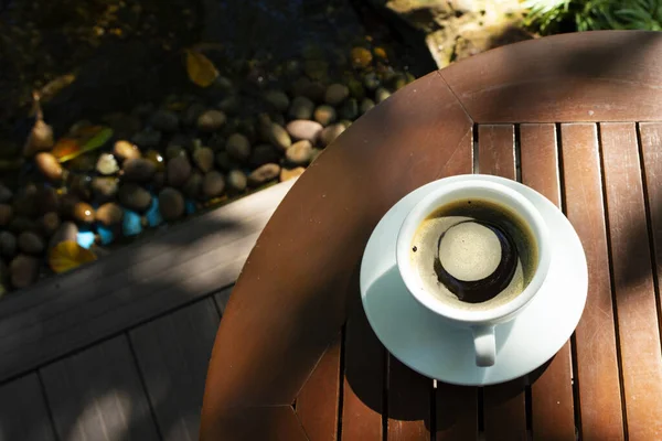 Morning cup of coffee and nature on green background .