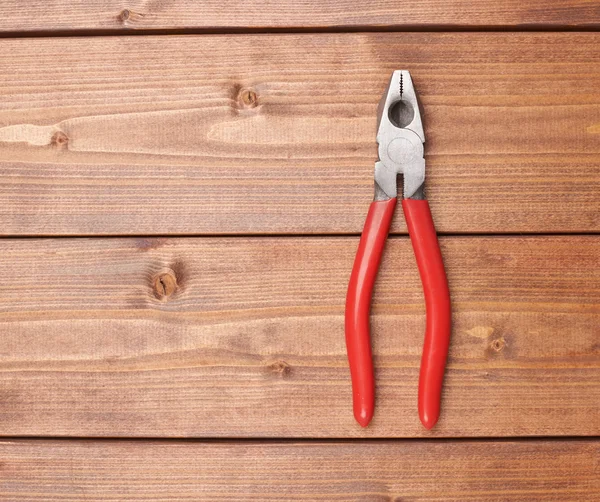 Linemans combination pliers hand tool on wooden surface — Stock Photo, Image