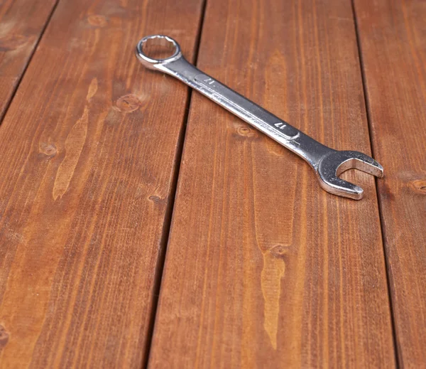 Wrench chrome metal spanner instrument on wooden surface — Zdjęcie stockowe