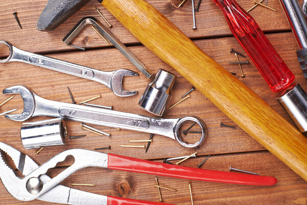 Set of different work tools on wooden surface