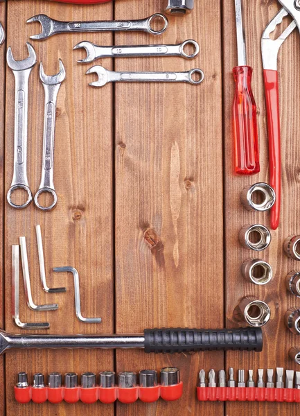 Set of different work tools on wooden surface