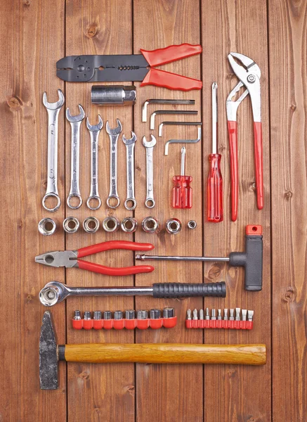 Set of different work tools on wooden surface