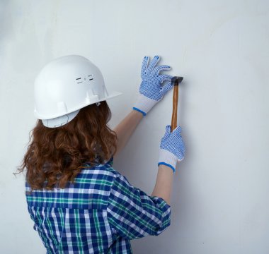 Young woman in casual clothes in front of white wall