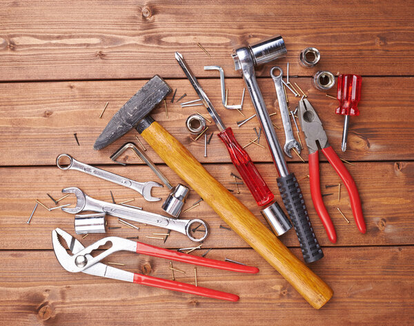 Set of different work tools on wooden surface