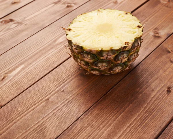 Raw cut pineapple on wooden surface table