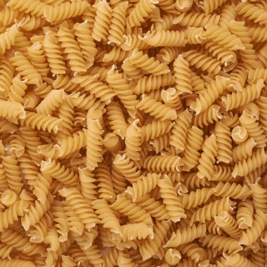 Soyut arka plan olarak rotini sarı makarna yığını