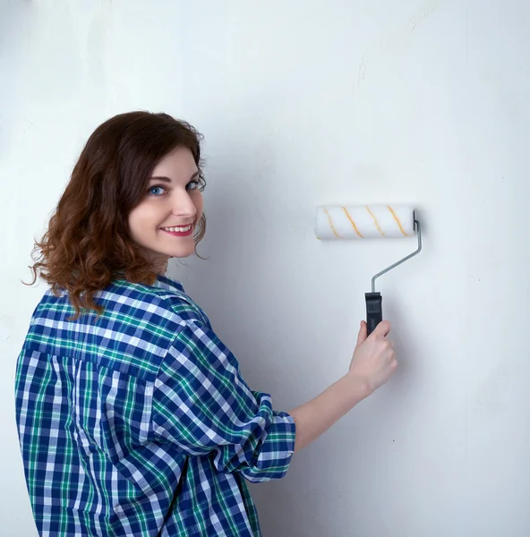 Young woman in casual clothes in front of white wall Εικόνα Αρχείου