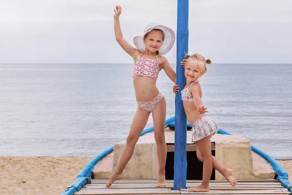 Two Little Girls Swimwear Standing White Blue Boat Sand Sea — Stock Photo, Image