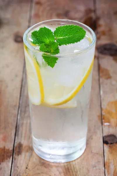 Glass, lemon, lime on wooden — Stock Photo, Image