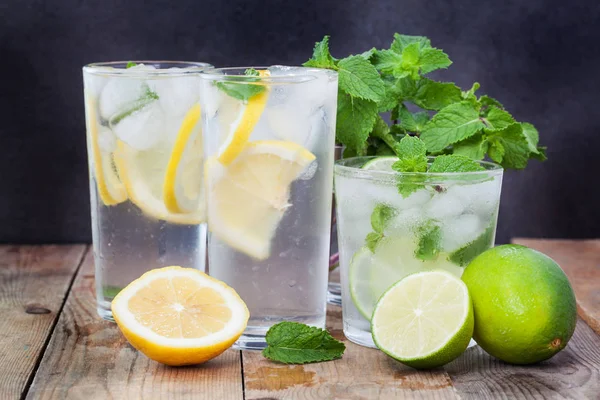 Glass, lemon, lime on wooden — Stock Photo, Image