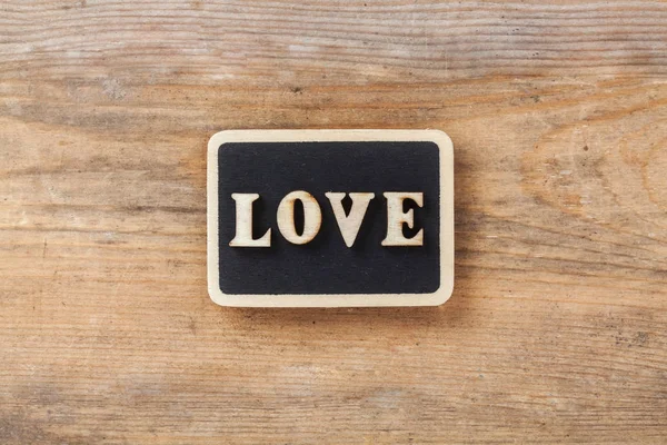 Letter Love on wooden background — Stock Photo, Image