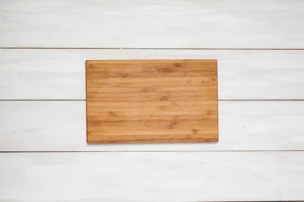 Cutting board on wood white — Stock Photo, Image