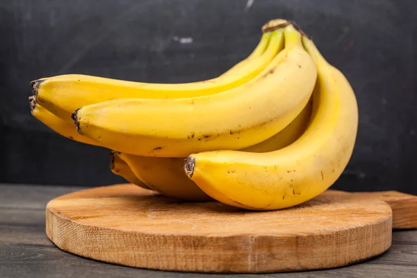 Banana on chopping wood board — Stock Photo, Image