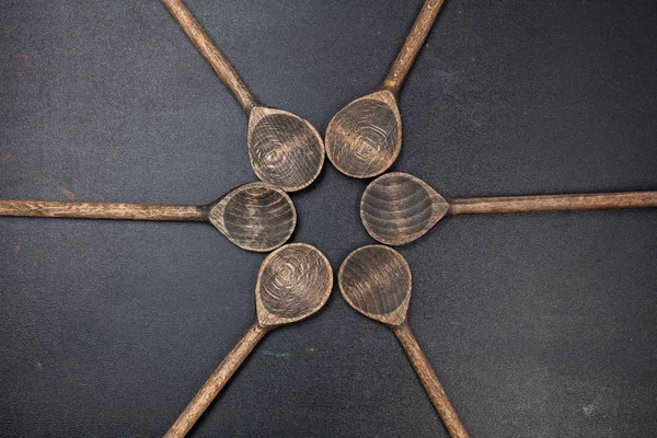 Wood spoons on blackboard table — Stock Photo, Image