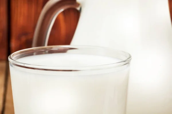 Jar of milk wooden background — Stock Photo, Image