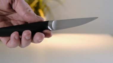 Close up of Hand with knife on white background. Close up.