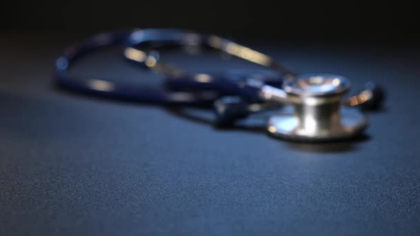 Hand man puts pills background of pills on table. Stethoscope on background. Close up. — Stock Video