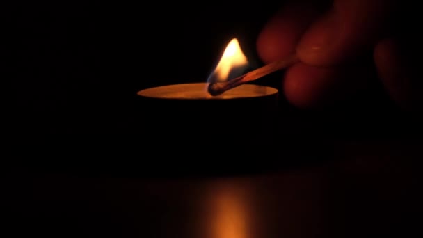 Light a candle in total darkness. Close up. — Stock Video