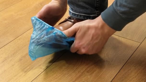 Putting on shoe blue covers in the hospital Close up. — Stockvideo