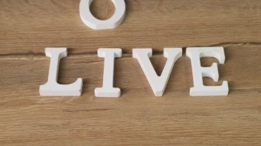 Letters word Live change on Love. Close up.