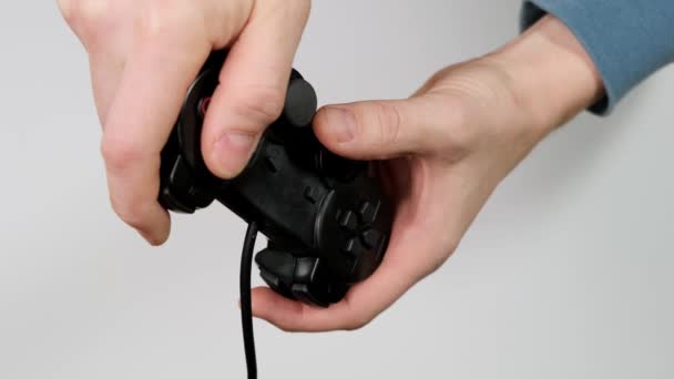 Hand holding joystick and play on white background. Close up. — Αρχείο Βίντεο