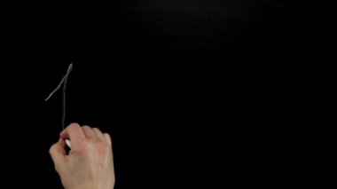 Hand writes on the blackboard with chalk one, two, three, four. Close up,