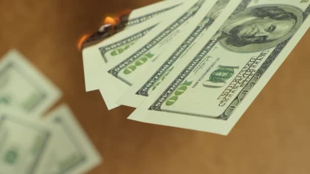 Dollar money burning on wooden background, economic crisis. Close up. — Stok video