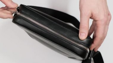 Black leather wallet in a man handbag. Close up.