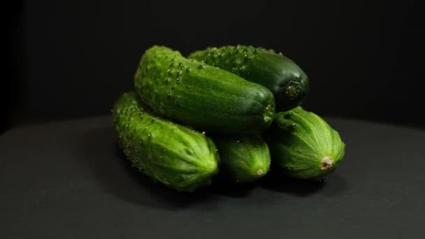 Fresh cucumber are on the rotating on Black background. Close up. — 비디오