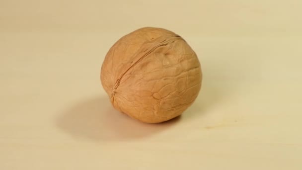 Walnut Rotating on wooden background. Close up. — 图库视频影像