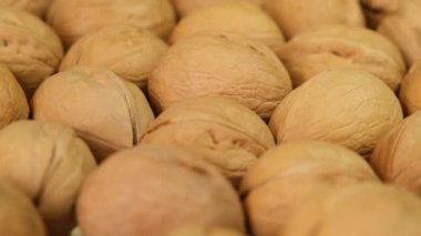 Walnut Rotating on wooden background. Close up.