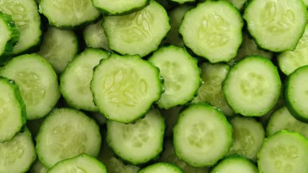 Top view of fresh sliced cucumber rotation. Close up. — Stock Video