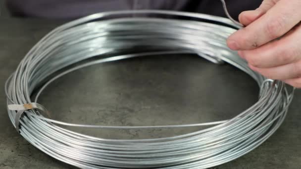 Metal copper wire on the spool in hand. Close up. — Stock Video