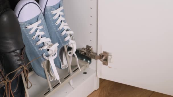 Shoe rack storage in wardrobe. Hand take one. Close up. — Stock Video