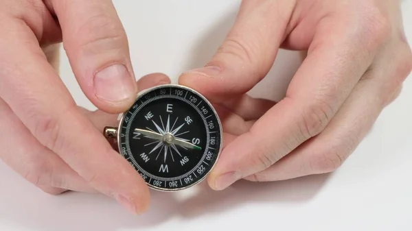 Hand holding a compass on white background. Close up. — Stock Photo, Image