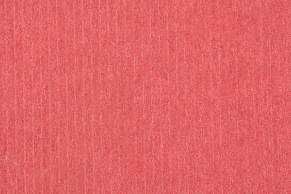 Ein roter Papierhintergrund mit Muster. Ansicht von oben. — Stockfoto