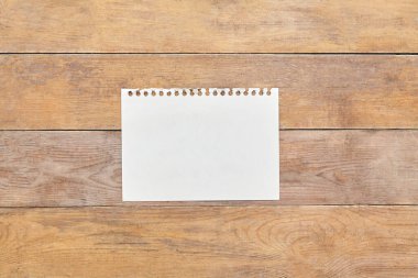 Kağıt bloknot kağıdı, tahta masa. Üst görünüm.
