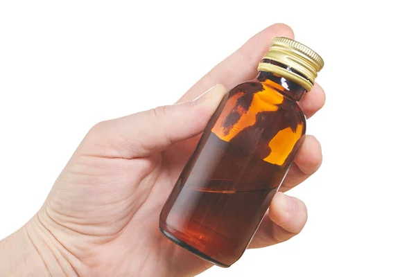 Hand with small bottle isolated on white background. Close up — Stock Photo, Image