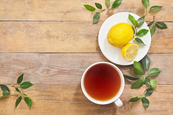 Tea with lemon on wooden table background with copy space. Top view. — Stock Photo, Image