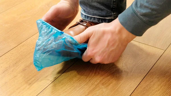 Putting on shoe blue covers in the hospital Close up. — Stock Photo, Image