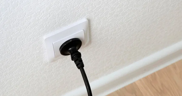 Hand Inserting black Power Plug into an white Electricity Socket. Close up. — Stock Photo, Image