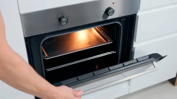 Opening Oven in white kitchen witk light. — Stock Photo, Image