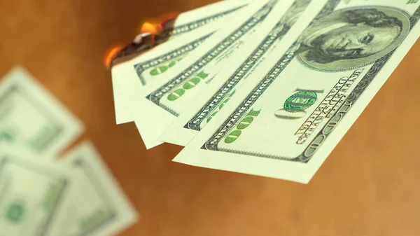 Dollar money burning on wooden background, economic crisis. Close up. — Stok fotoğraf