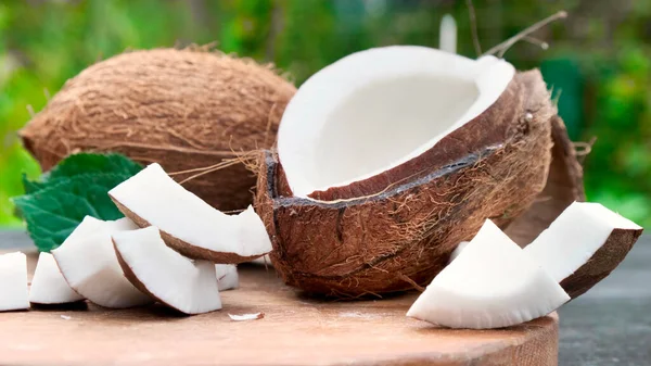 Pouring fresh coconut milk on wooden table. — Stock Photo, Image